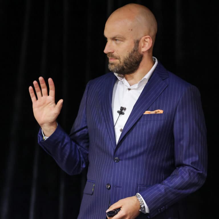 Andrus Albi speaking on stage