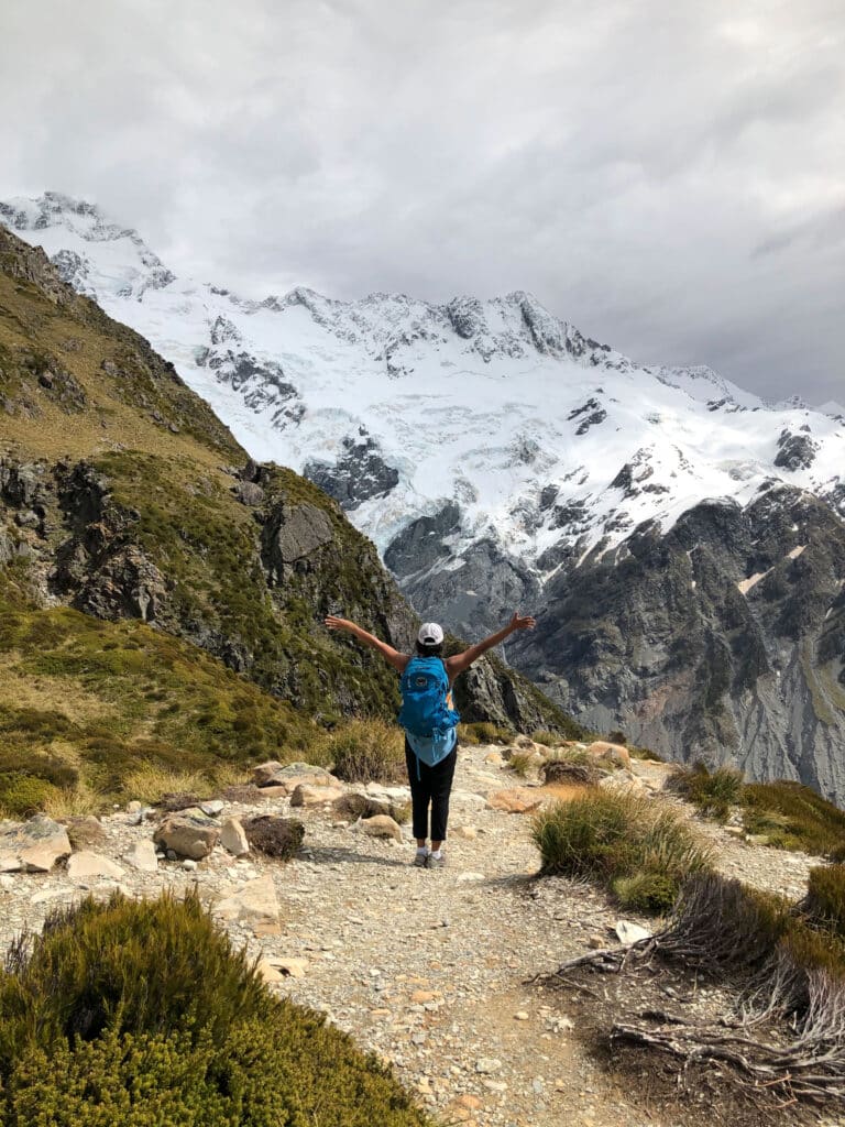 client celebrating on top of a mountain